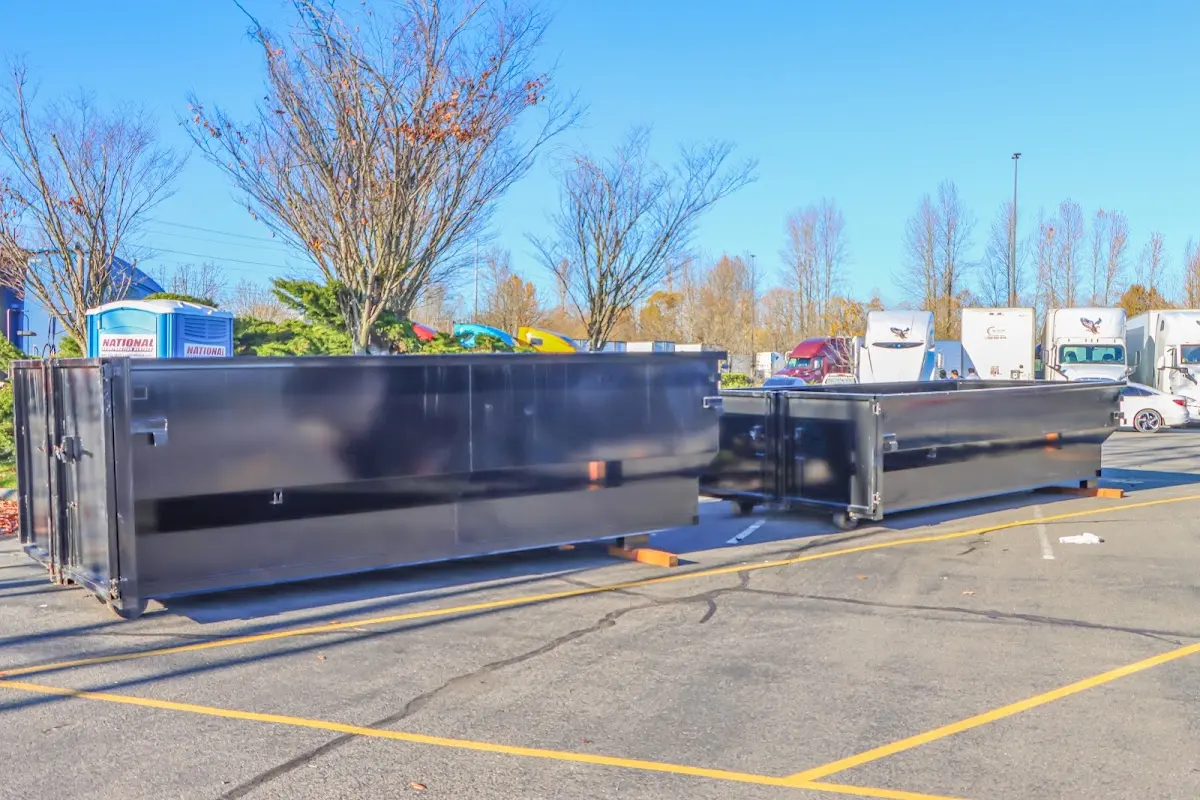 Professional dumpster rental service with roll-off container on residential driveway in Nanticoke